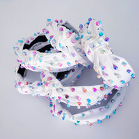 White and iridescent pearl knotted headband hair accessory